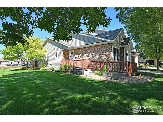 a view of a house with a big yard and large tree