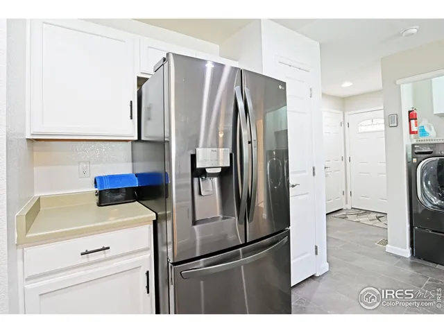 a kitchen with a refrigerator and a sink