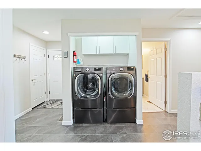 a utility room with wooden floor washer and dryer