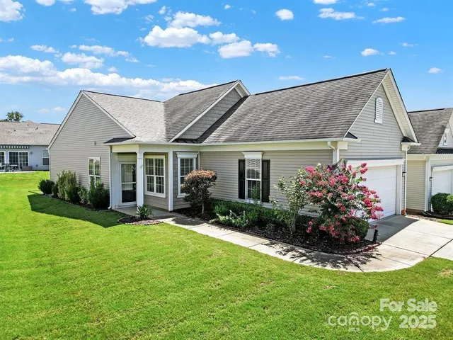 a front view of a house with a garden and patio