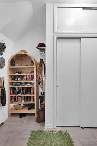 a living room with furniture a flat screen tv and a window