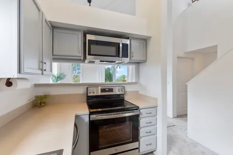a kitchen with stainless steel appliances a stove a microwave and sink