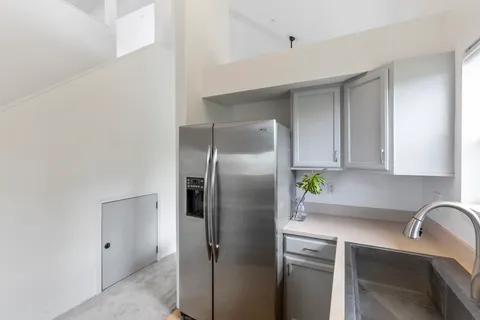 a kitchen with stainless steel appliances granite countertop a refrigerator and a sink