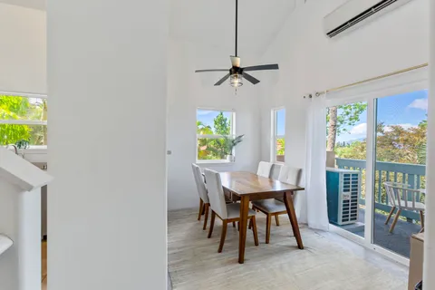a view of a dining room with furniture and a window