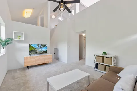 a living room with furniture and a chandelier