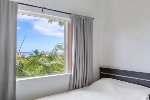 a bed room with a bed and a window