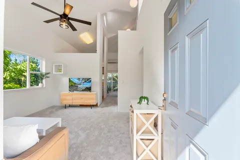 a view of living room kitchen with furniture and wooden floor