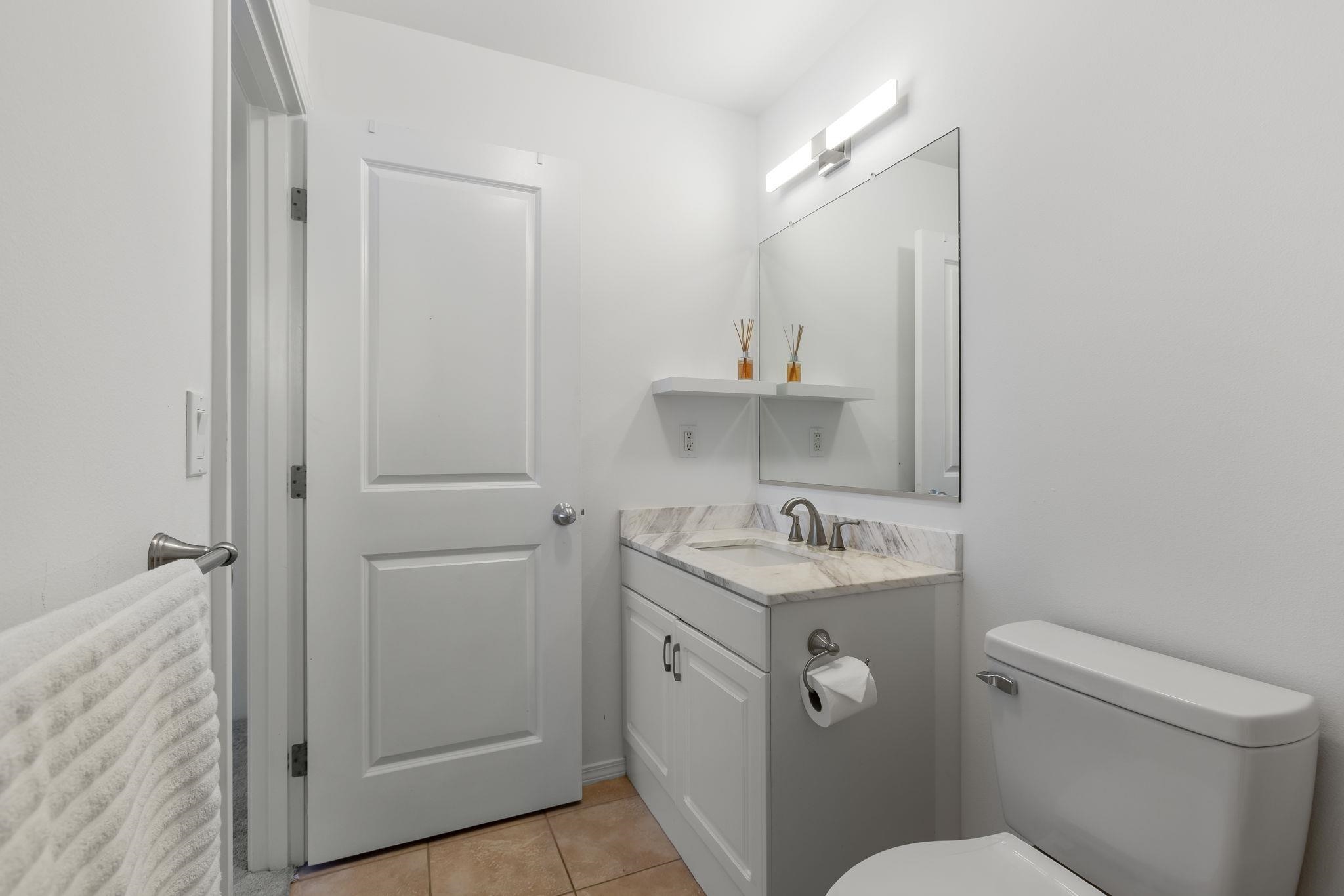 10 Heather Lane, Unit 231 Lahaina, HI 96761 - Photo 31 of 44 a bathroom with a toilet sink and mirror