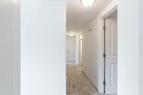 a view of a hallway with bathroom