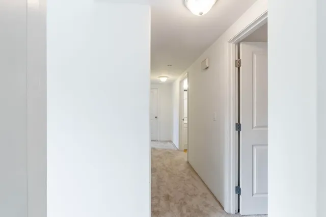 a view of a hallway with bathroom