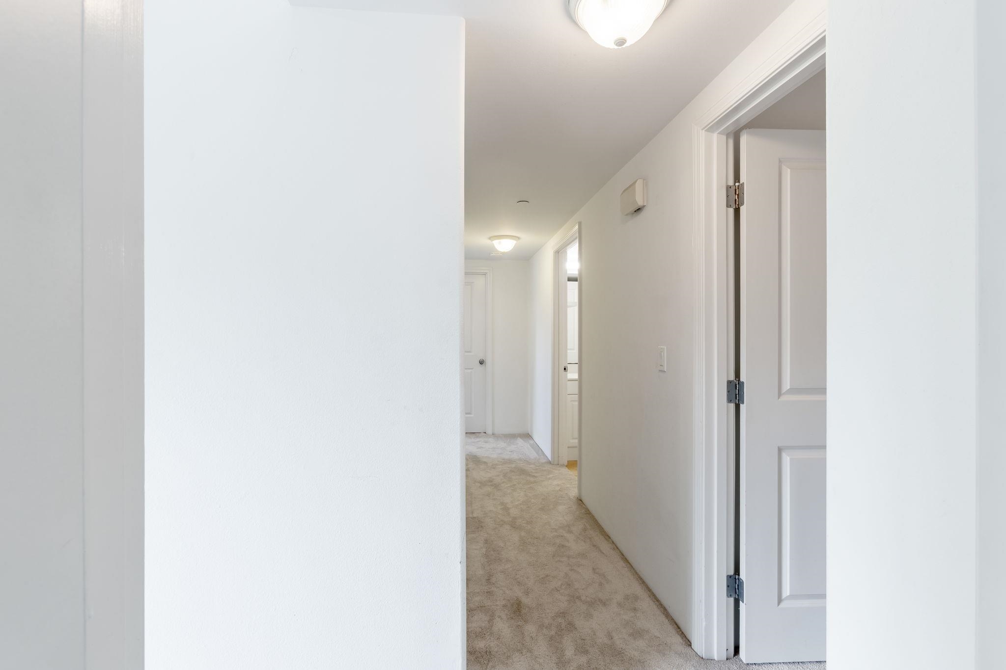 10 Heather Lane, Unit 231 Lahaina, HI 96761 - Photo 40 of 44 a view of a hallway with wooden shelves