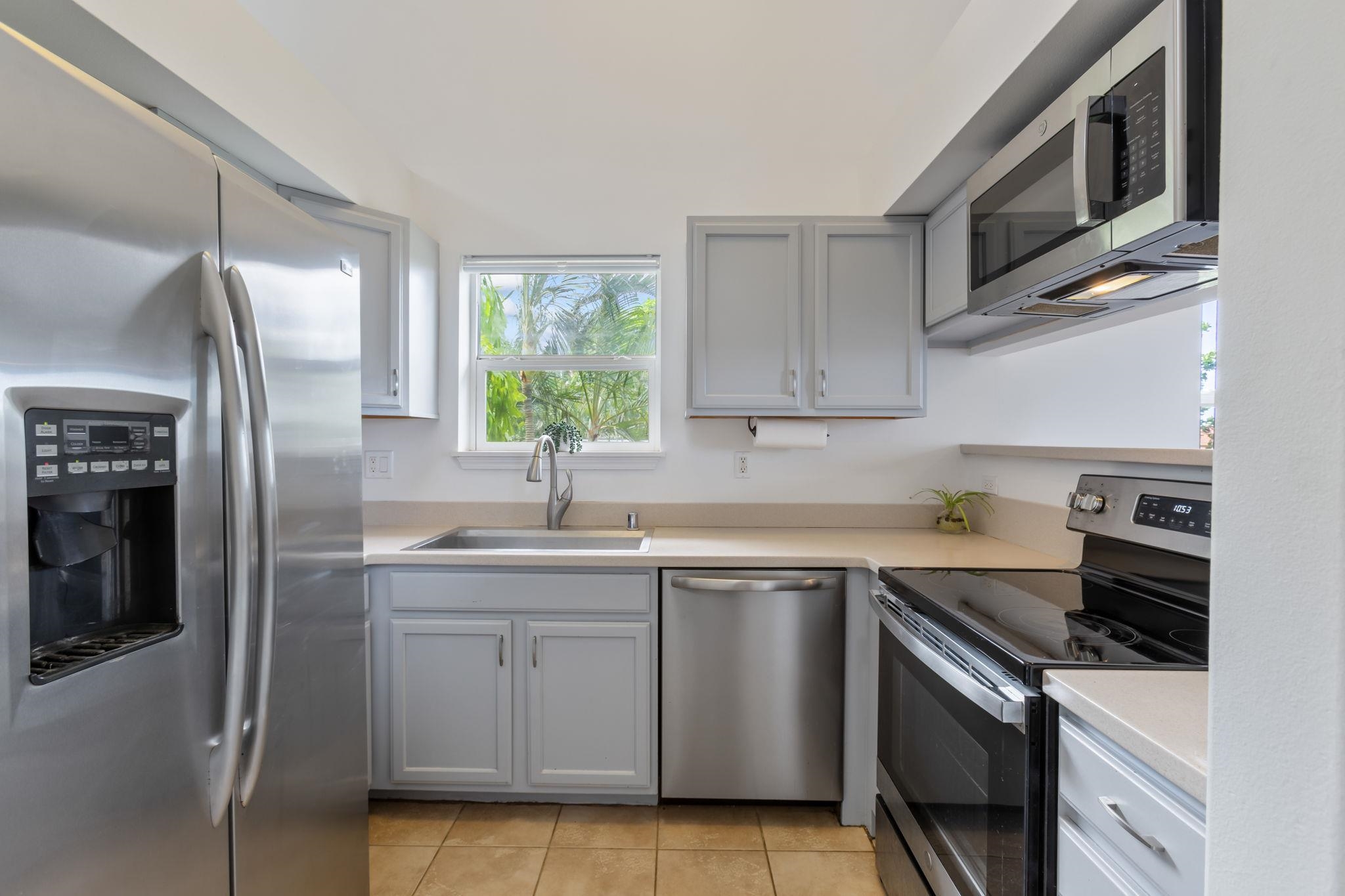 10 Heather Lane, Unit 231 Lahaina, HI 96761 - Photo 9 of 44 a kitchen with stainless steel appliances granite countertop a sink stove and refrigerator