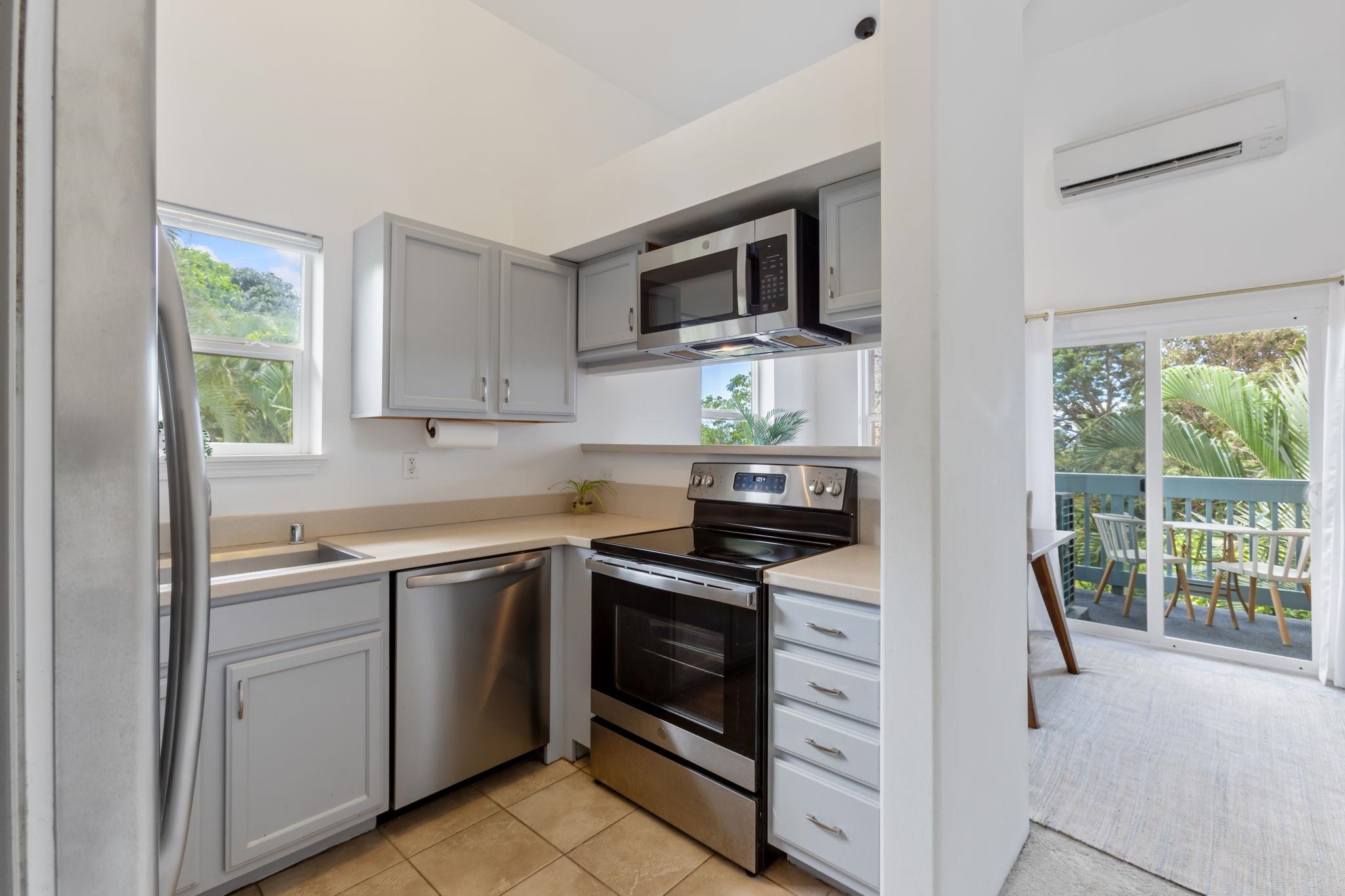 10 Heather Lane, Unit 231 Lahaina, HI 96761 - Photo 10 of 44 a kitchen with stainless steel appliances a stove sink and microwave