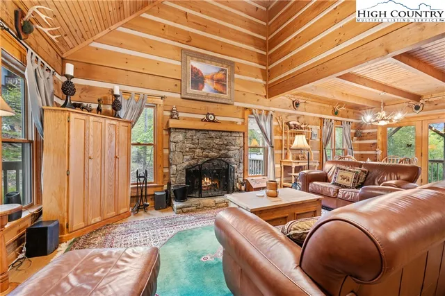 a living room with furniture a fireplace and a table