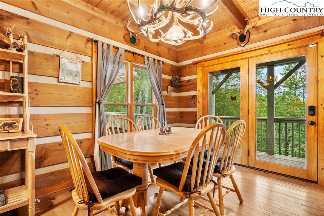 207 Lake Road Beech Mountain, NC 28604 - Photo 13 of 32 a dining room with wooden floor table and chairs