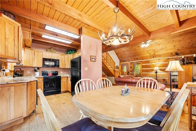 a view of a kitchen with a dining table and chairs