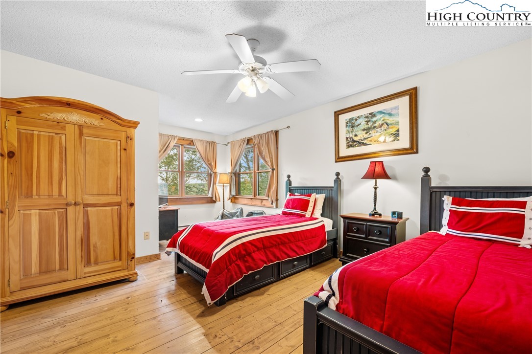 207 Lake Road Beech Mountain, NC 28604 - Photo 23 of 32 a bedroom with two beds and wooden floor