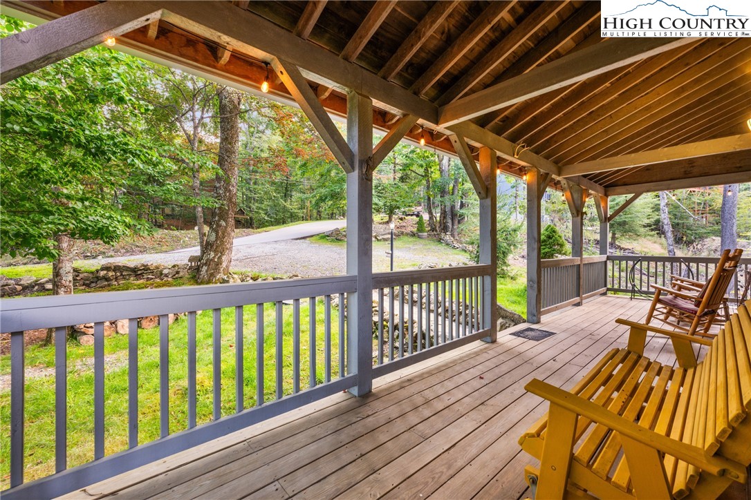 207 Lake Road Beech Mountain, NC 28604 - Photo 5 of 32 a view of a balcony with wooden floor