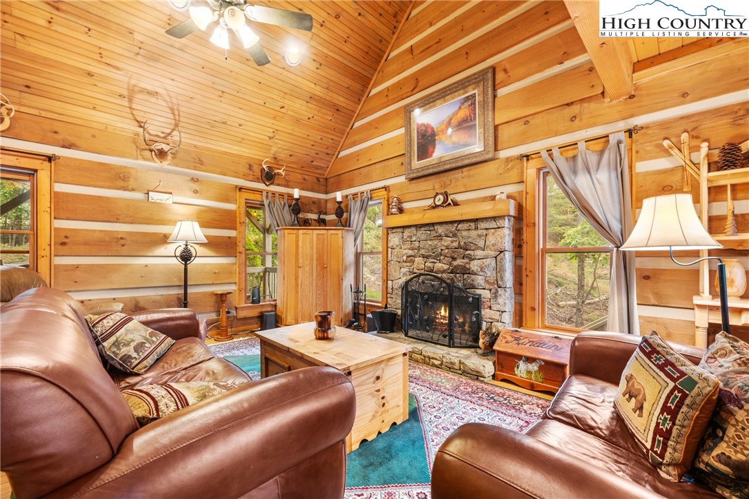 207 Lake Road Beech Mountain, NC 28604 - Photo 10 of 32 a outdoor living space with furniture and a fireplace