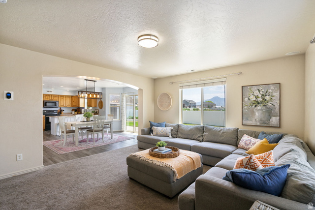 1393 West 150 North Springville, UT 84663 - Photo 6 of 31 Open-concept living area featuring soft gray carpeting, a large picture window, and recessed lighting
