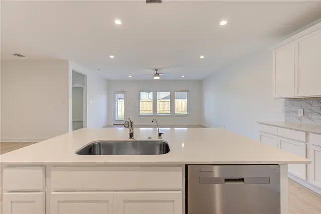 a kitchen with a sink and a refrigerator