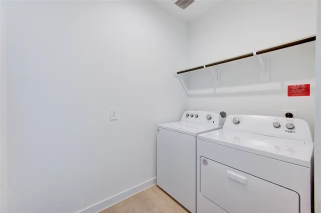 a view of storage and utility room with washer and dryer