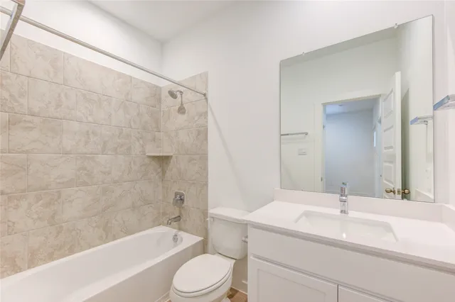 a bathroom with a sink a toilet and bathtub