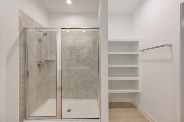 a bathroom with a glass shower door