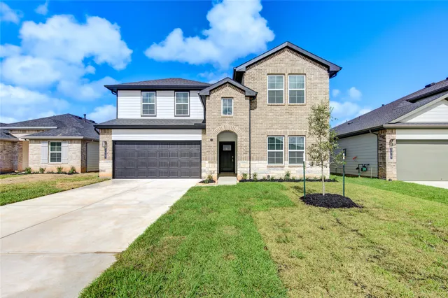 a front view of a house with yard