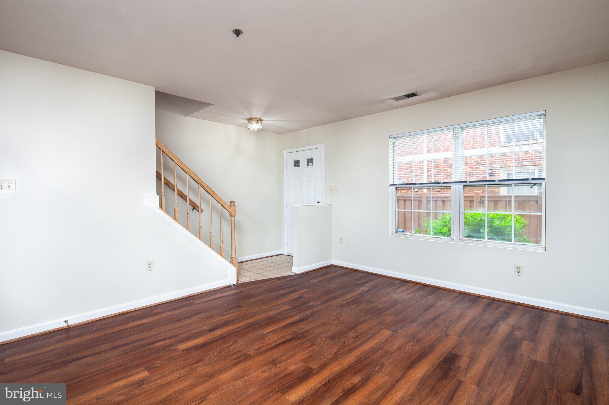 3040 South Glebe Road, Unit 3040 Arlington, VA 22206 - Photo 2 of 33 a view of an empty room with wooden floor and a window