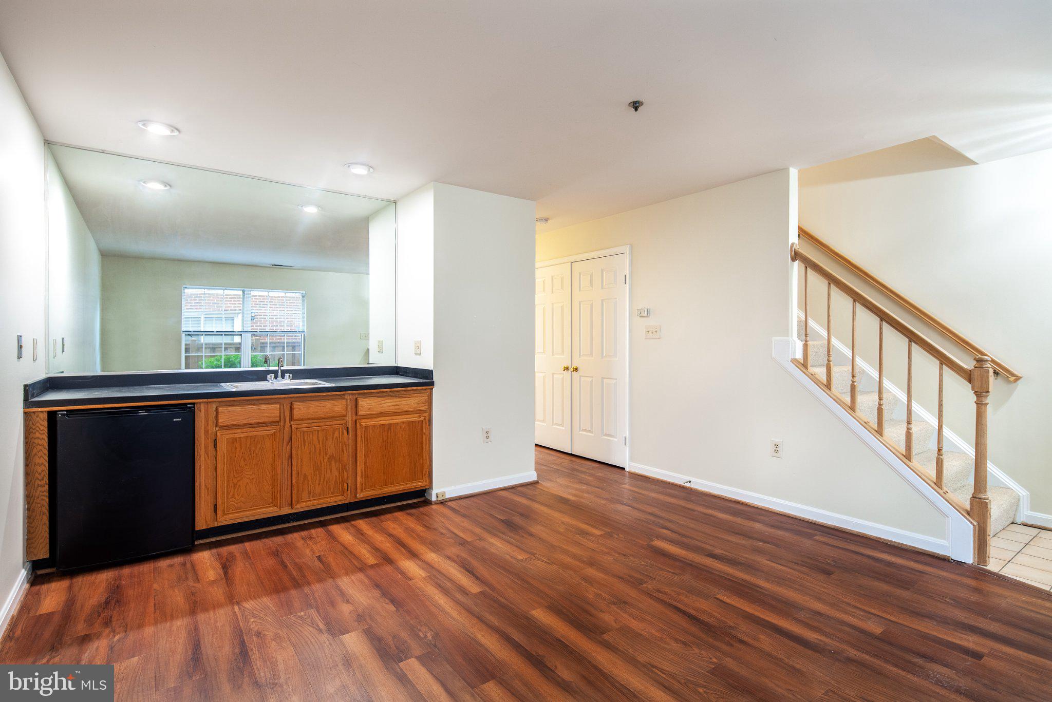 3040 South Glebe Road, Unit 3040 Arlington, VA 22206 - Photo 3 of 33 a view of an empty room with wooden floor and a window