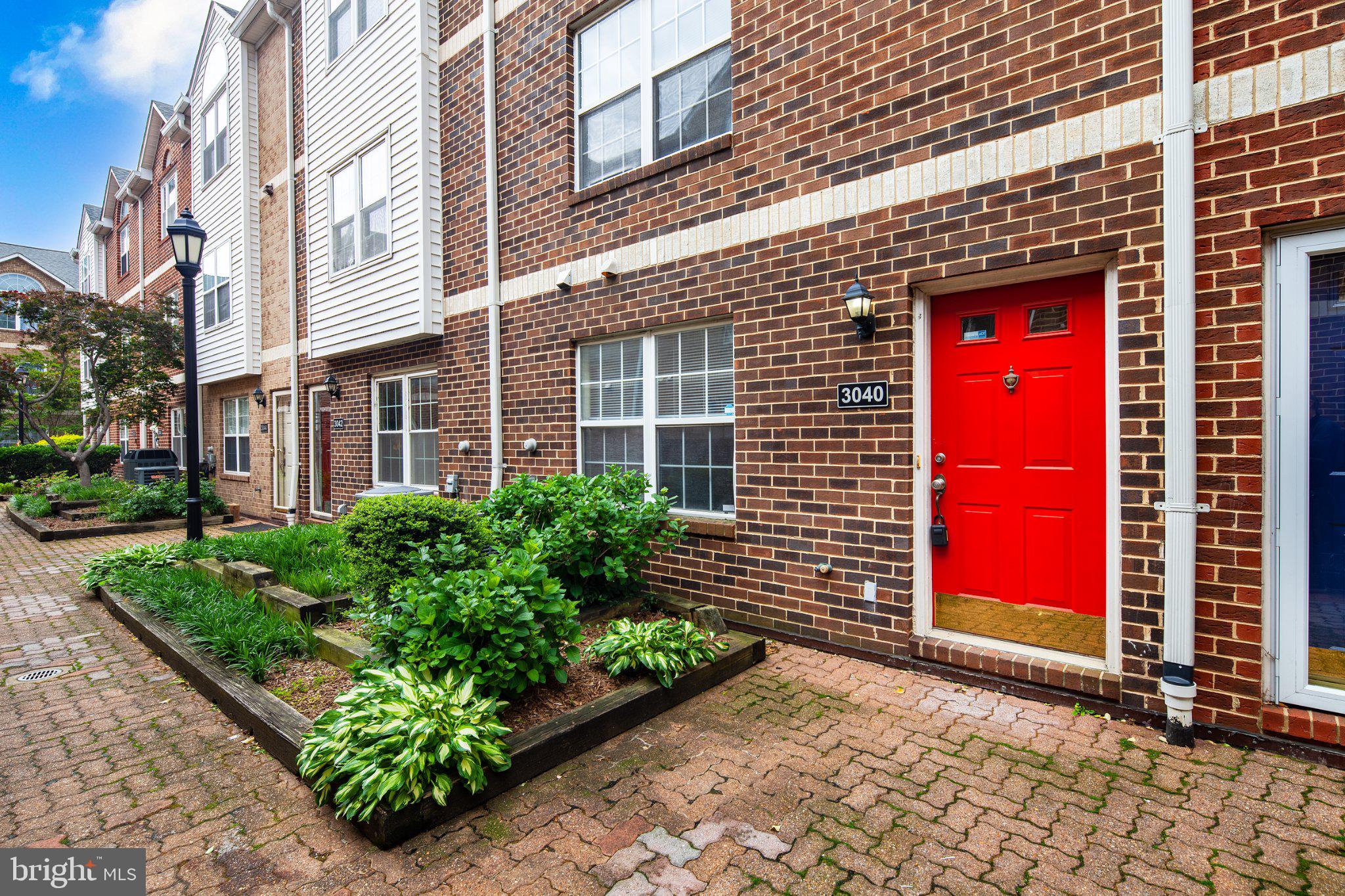 3040 South Glebe Road, Unit 3040 Arlington, VA 22206 - Photo 33 of 33 a view of a brick building with a bench in front of house