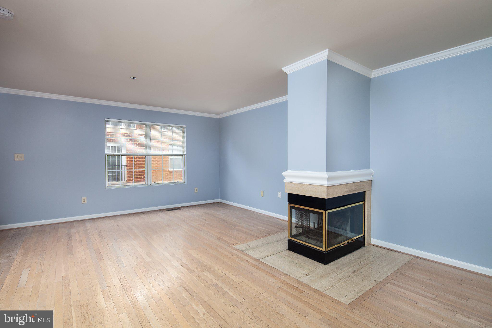 3040 South Glebe Road, Unit 3040 Arlington, VA 22206 - Photo 5 of 33 a view of an empty room with wooden floor and a window