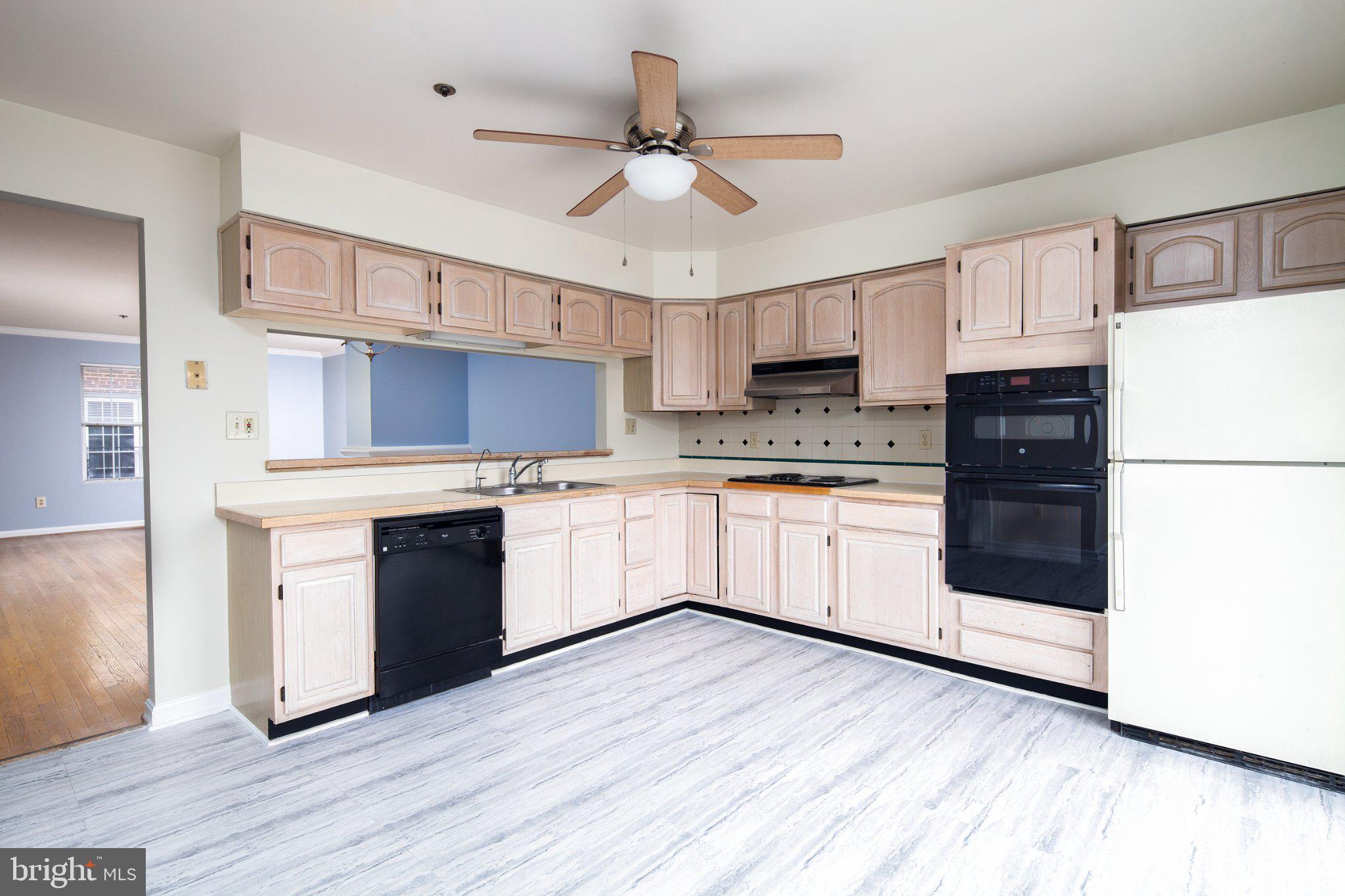 3040 South Glebe Road, Unit 3040 Arlington, VA 22206 - Photo 7 of 33 a kitchen with a white cabinets and white appliances