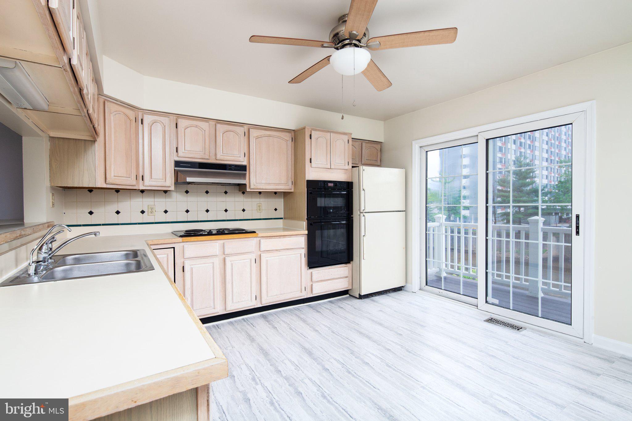 3040 South Glebe Road, Unit 3040 Arlington, VA 22206 - Photo 9 of 33 a kitchen with stainless steel appliances a refrigerator sink and microwave