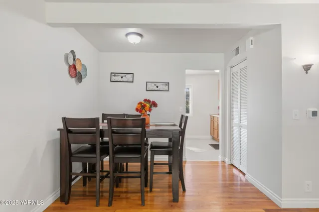 a view of a dining room with furniture and wooden floor