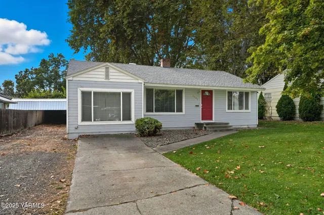a front view of a house with yard patio and green space