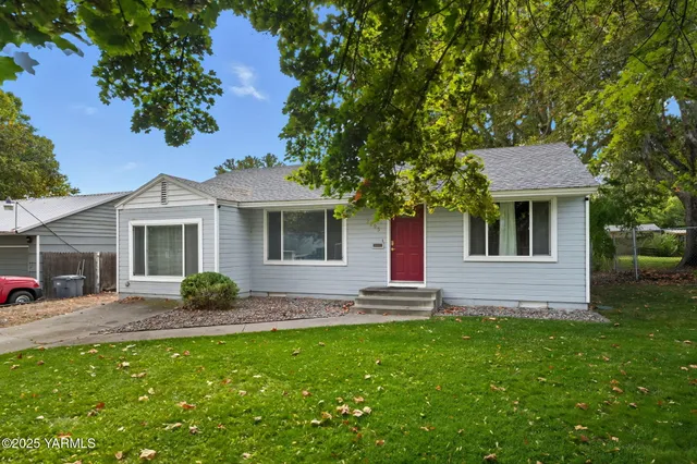 a house view with outdoor seating space and garden