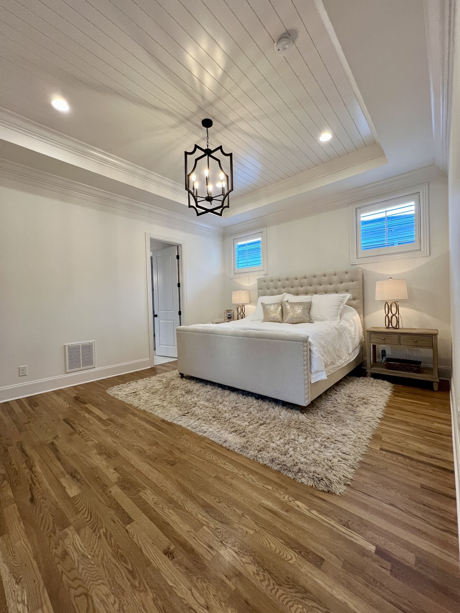 2001 Erwin Street Franklin, TN 37064 - Photo 15 of 30 a spacious bedroom with a bed and a chandelier