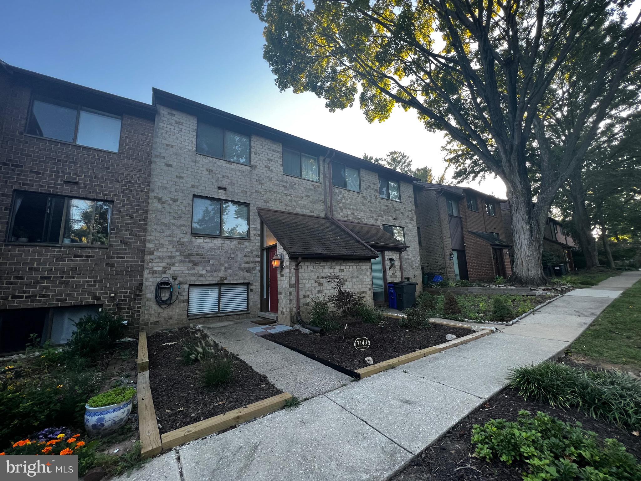 7148 Lasting Light Way Columbia, MD 21045 - Photo 1 of 20 a front view of a house with garden