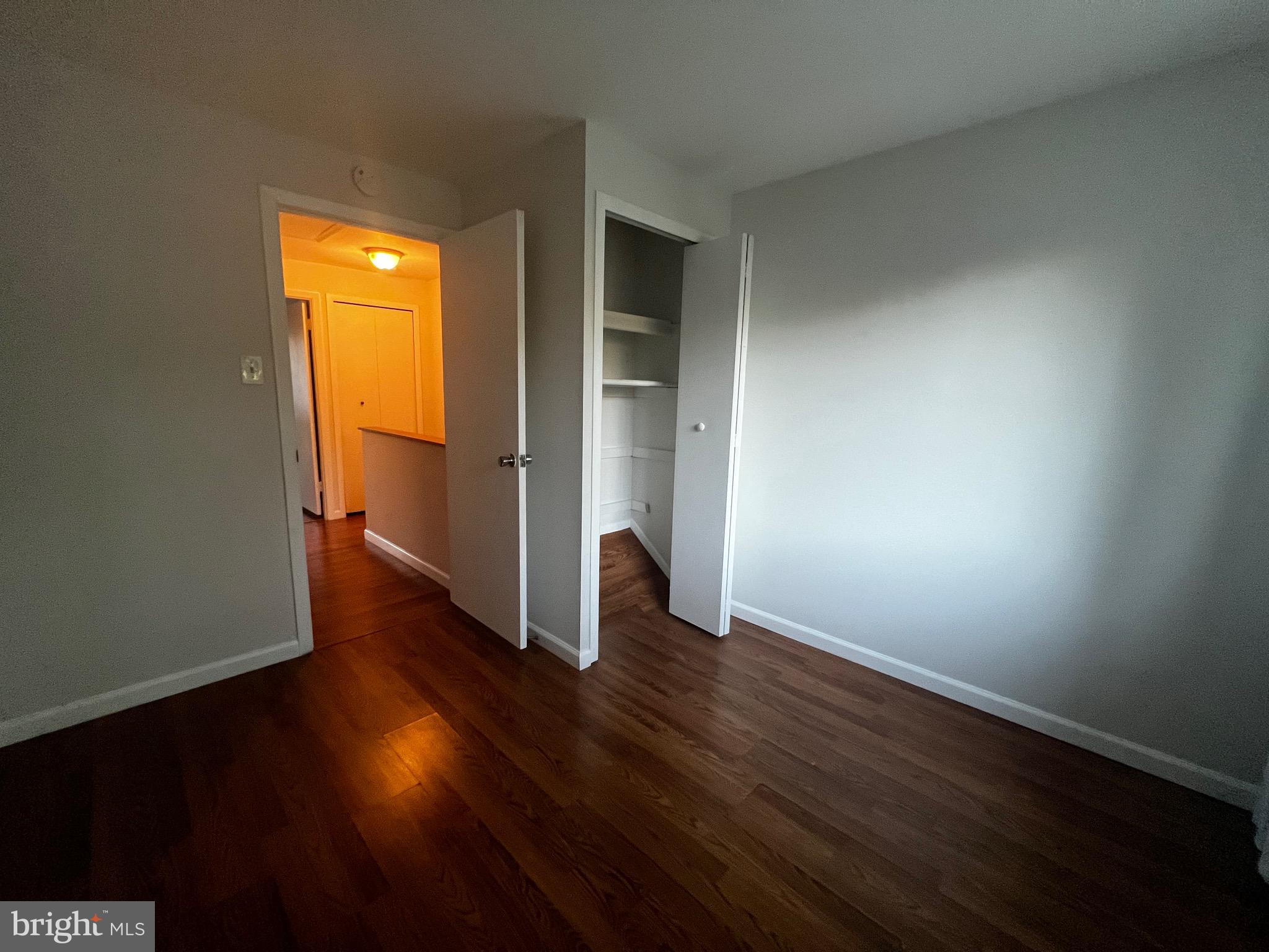 7148 Lasting Light Way Columbia, MD 21045 - Photo 13 of 20 a view of an empty room with wooden floor and a window