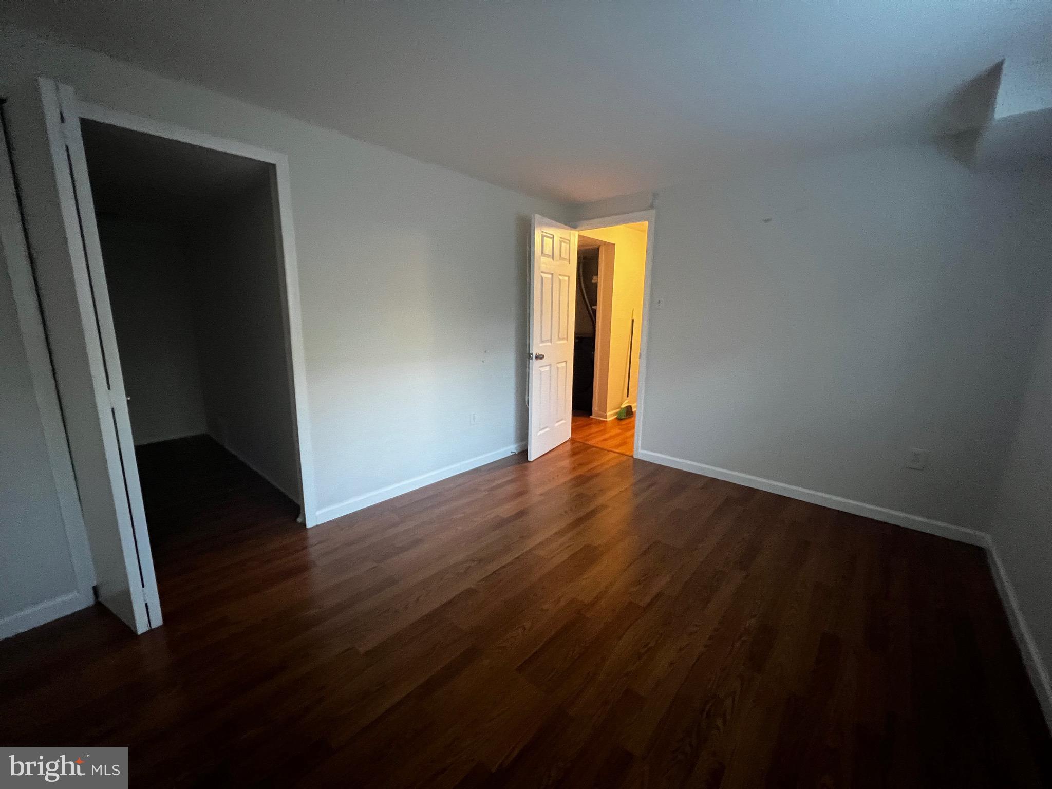 7148 Lasting Light Way Columbia, MD 21045 - Photo 15 of 20 a view of an empty room with wooden floor and a window