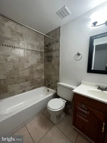 a bathroom with a toilet a sink and bathtub