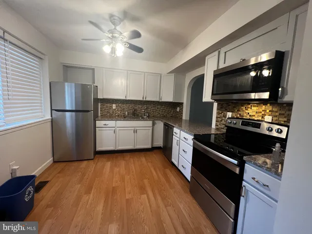 a kitchen with a refrigerator stove and microwave