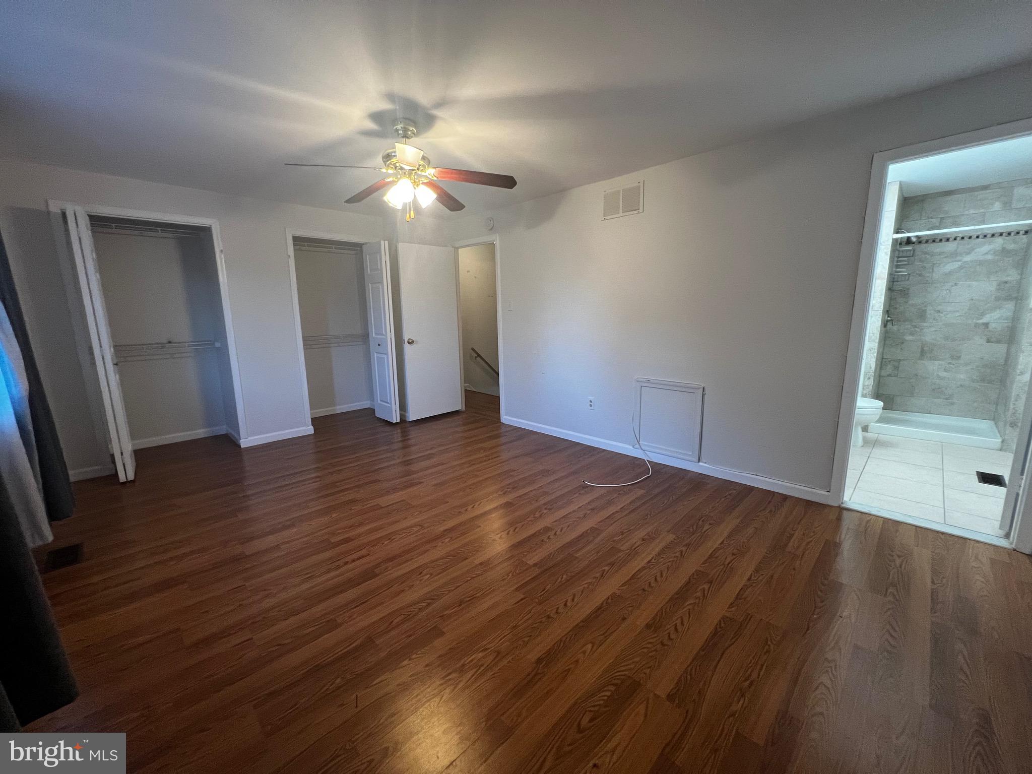 7148 Lasting Light Way Columbia, MD 21045 - Photo 9 of 20 a view of an empty room with wooden floor and a window