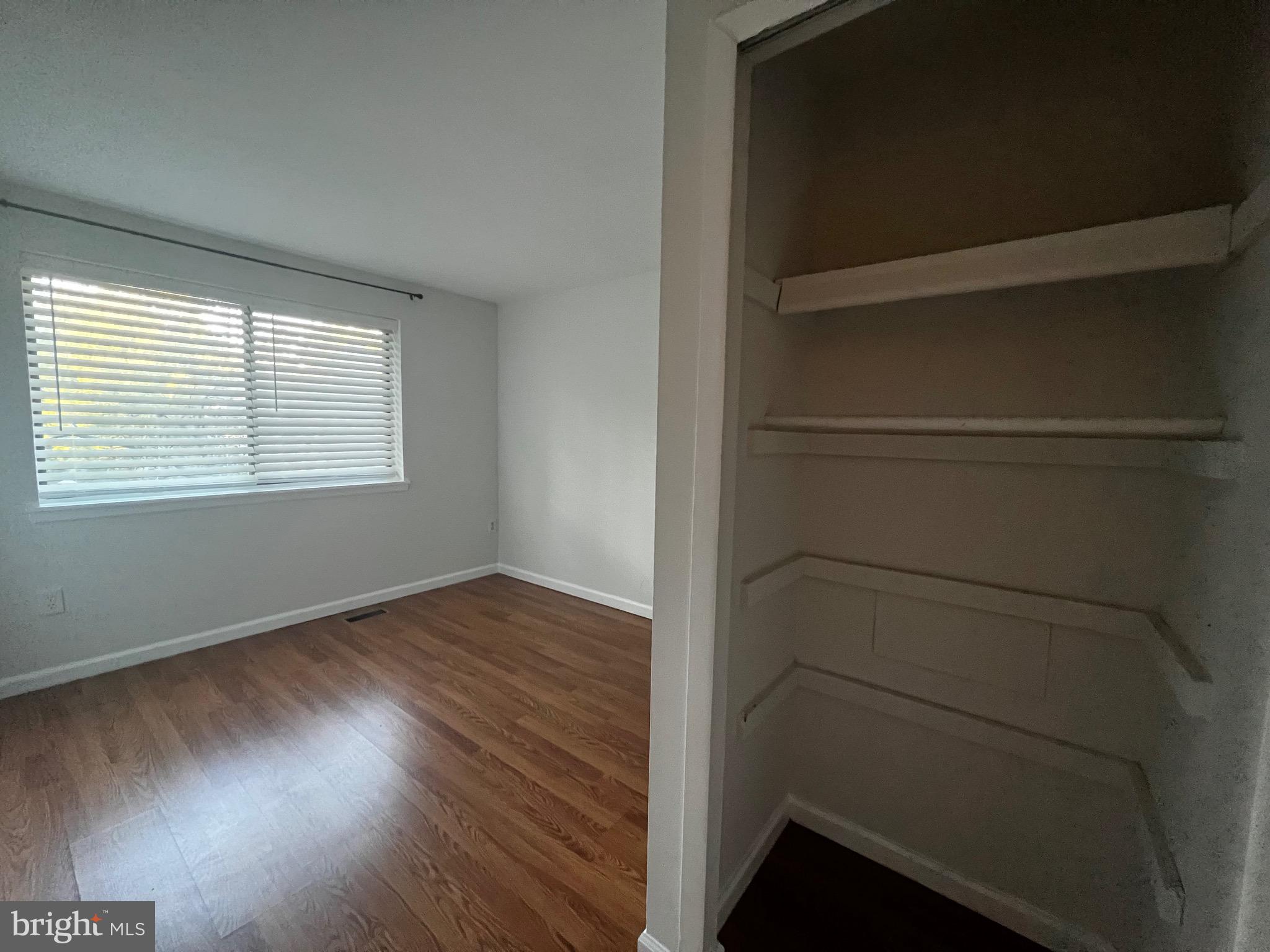 7148 Lasting Light Way Columbia, MD 21045 - Photo 10 of 20 a view of an empty room with wooden floor and a window