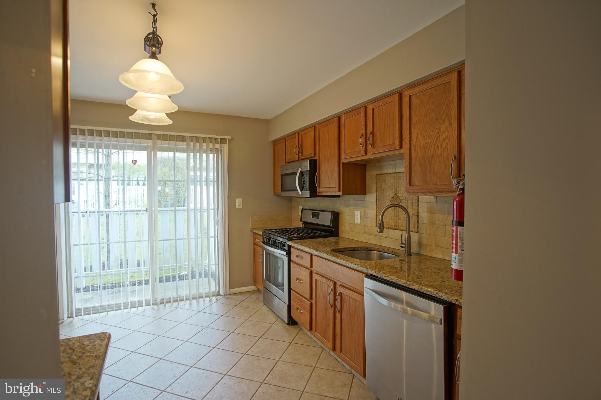 5808 Coventry Way Mount Laurel, NJ 08054 - Photo 12 of 41 a kitchen with stainless steel appliances granite countertop a stove a sink and a microwave