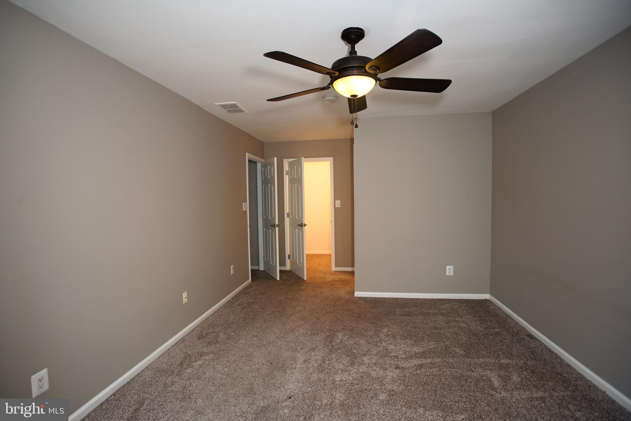 5808 Coventry Way Mount Laurel, NJ 08054 - Photo 36 of 41 a view of an empty room with window and a ceiling fan