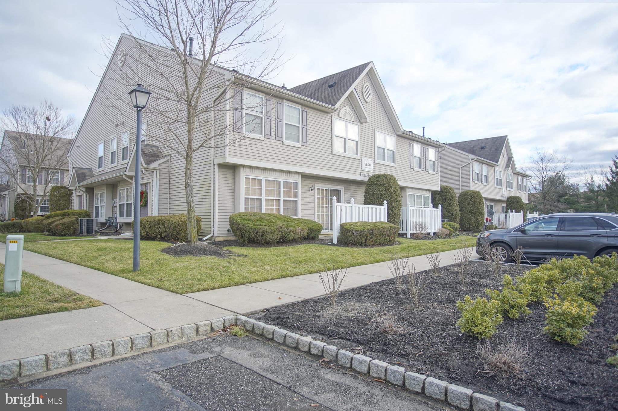 5808 Coventry Way Mount Laurel, NJ 08054 - Photo 5 of 41 a view of a big yard in front of a brick house