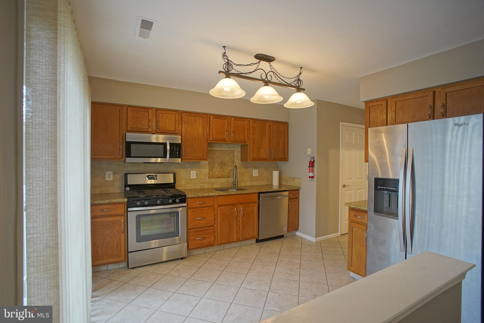 5808 Coventry Way Mount Laurel, NJ 08054 - Photo 10 of 41 a kitchen with stainless steel appliances a stove a refrigerator and a sink